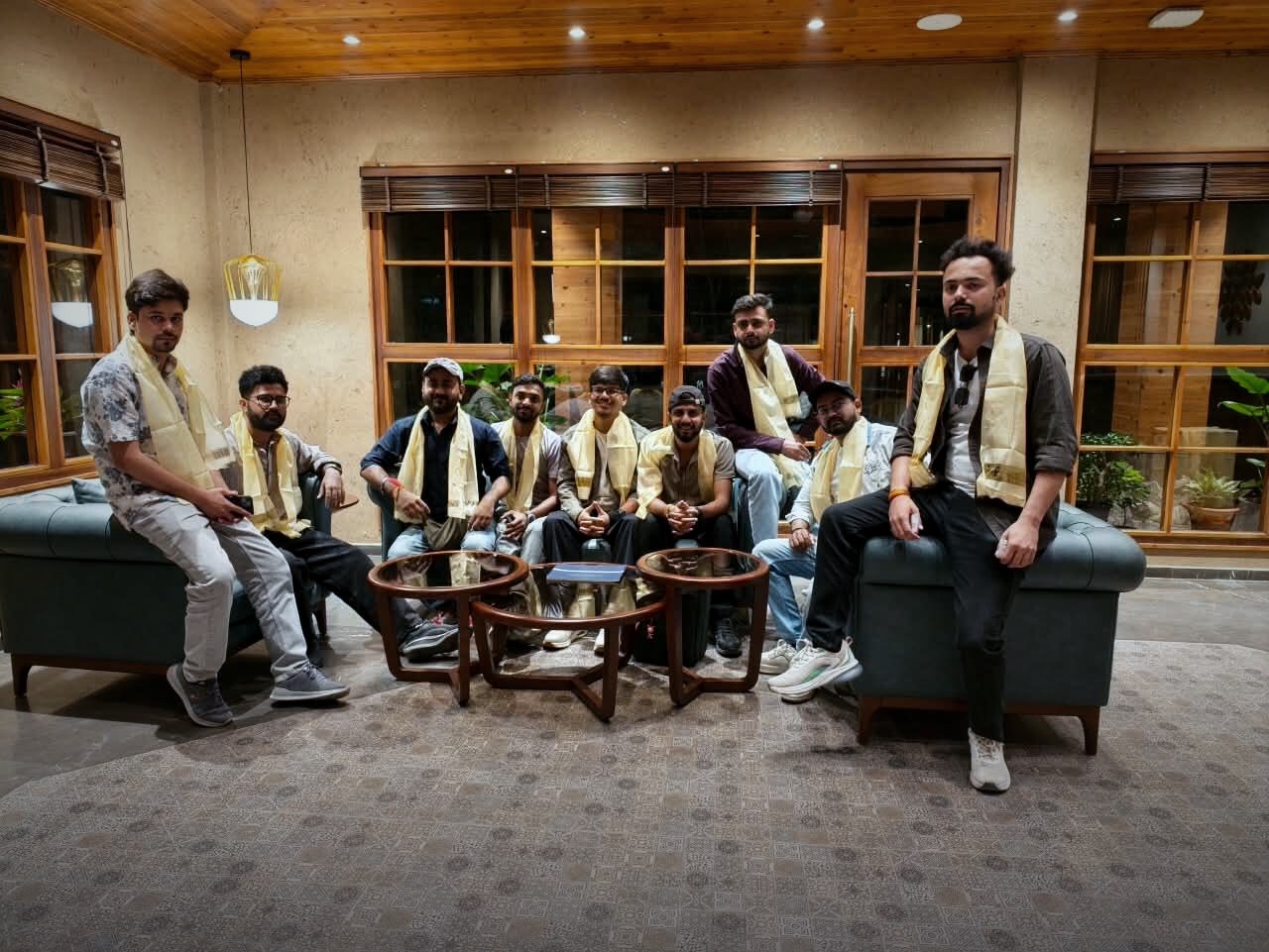The team welcomed with traditional khata scarves in a hotel lobby