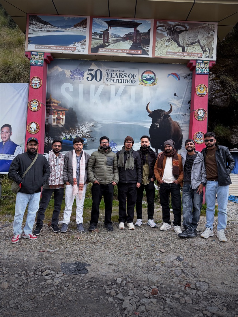 The Techcream team in winter jackets in front of the Sikkim welcome sign